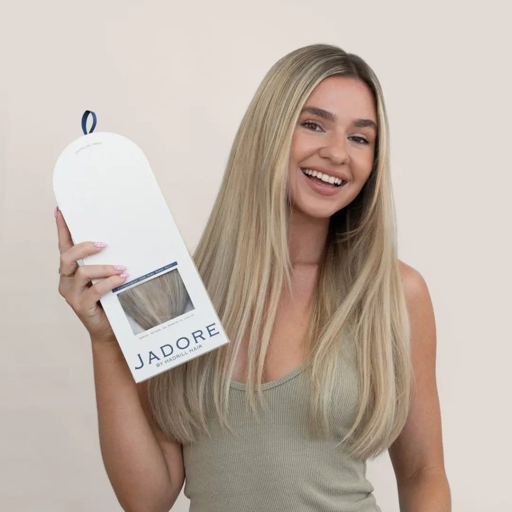Model holding the Jadore 8-piece Seamless clip-in set