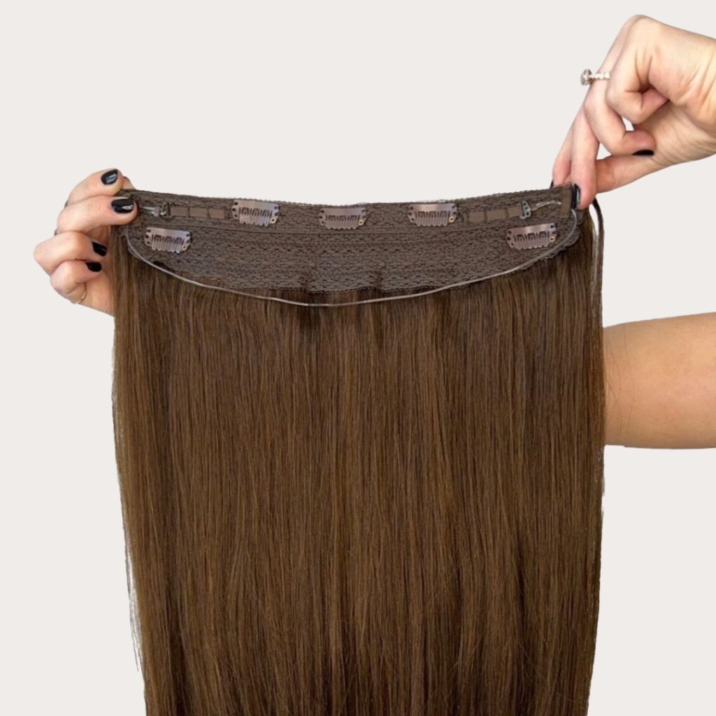 Brunette clip-in halo held open to show its wire and clips
