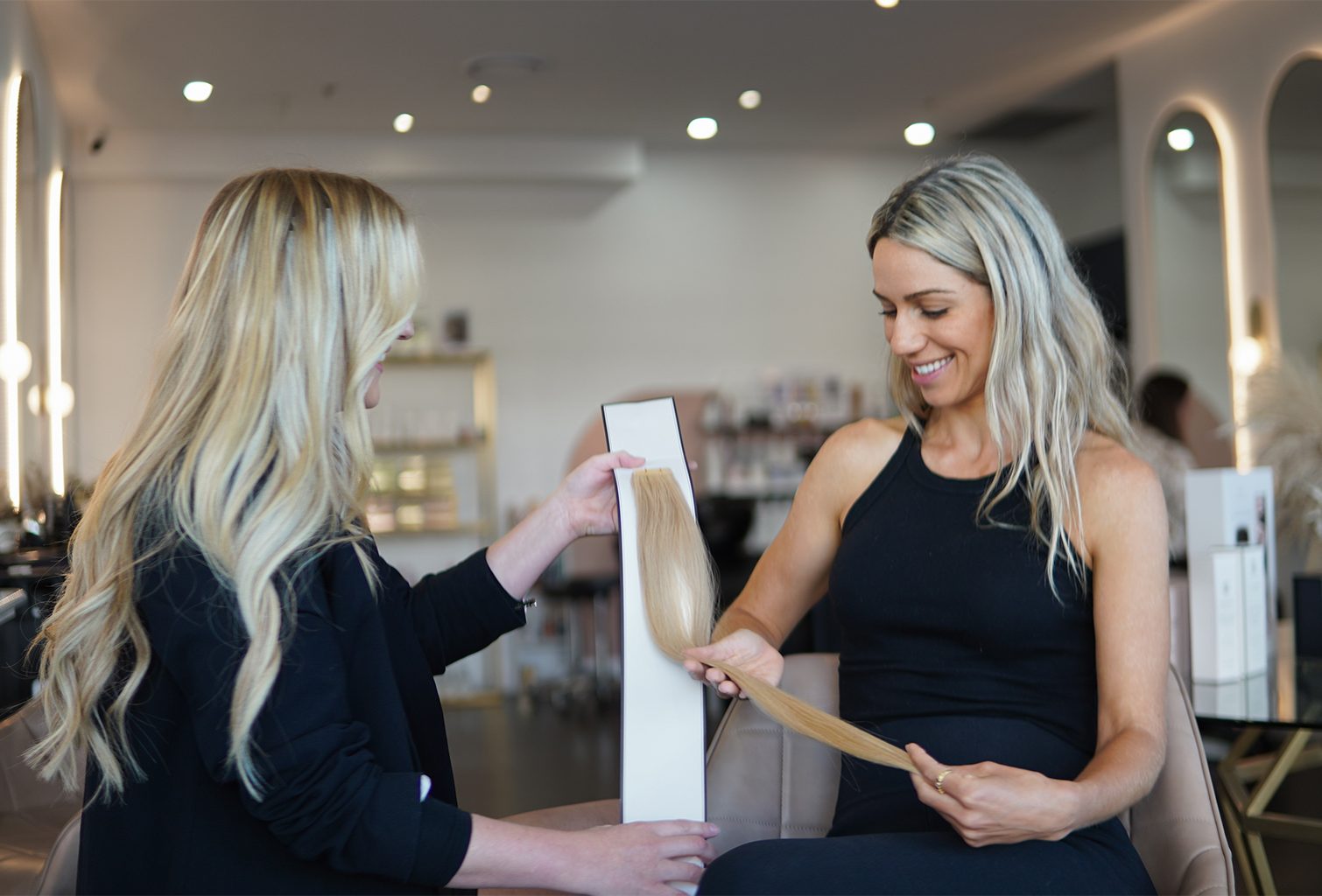 Woman getting advise on which extension type and colour method is best for her at an Emilly Hadrill Salon.