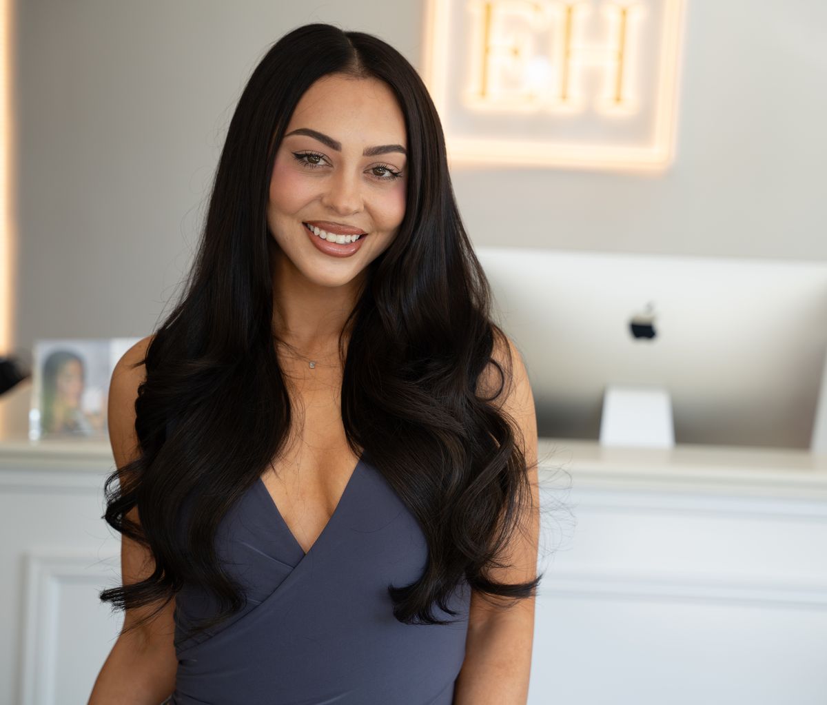 Emilee Hembrow smiling at EH reception with long wavy dark hair after her Signature Weft application